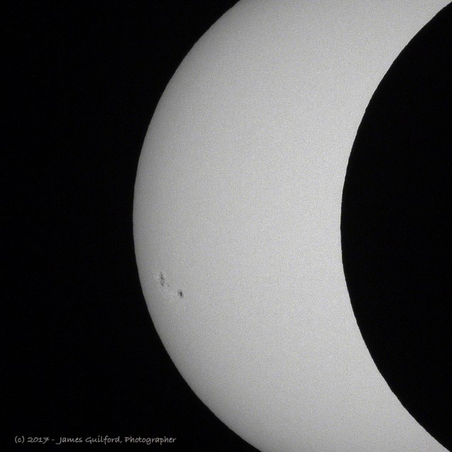 Photo: Edge of lunar silhouette shows mountains on Moon. Photo by James Guilford.