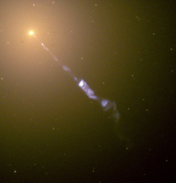 Streaming out from the center of M87 like a cosmic searchlight is one of nature’s most amazing phenomena: a black-hole-powered jet of subatomic particles traveling at nearly the speed of light. In this Hubble image, the blue jet contrasts with the yellow glow from the combined light of billions of unresolved stars and the point-like clusters of stars that make up this galaxy. Credits: NASA and the Hubble Heritage Team (STScI/AURA)
